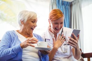 senior-woman-and-nurse-laughing Dementia Caregiver Training for Organizations